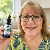 Customer Linda M. holding Pineal Guardian Advanced