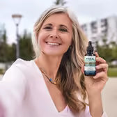 Customer Sandra J. holding Pineal Guardian Advanced